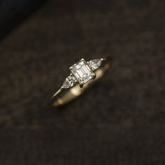 an engagement ring with three diamonds on it