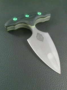 a knife with green eyes sitting on top of a table