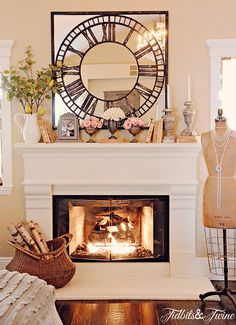 a living room with a fire place and mannequins in front of it