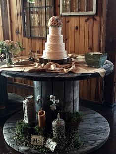 a wedding cake sitting on top of a wooden table