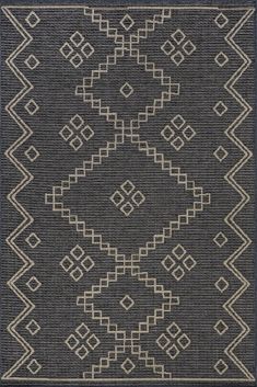 a black rug with white and beige designs on the bottom, in front of a gray background