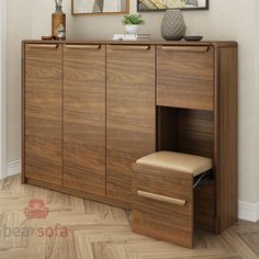 a wooden cabinet with two drawers and a mirror above it on the wall next to a chair