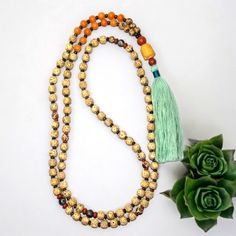 - Handcrafted Bodhi Seed | Tibetan Agate With Bronzite 8mm Gemstone Mala Necklace The Mala Is Made With 108 (8mm) Gemstone Beads. The Length Is Approximately 51.5" And Includes The Tassel. The Beads Are Bodhi Seed. The Spacer Beads In-Between The Bodhi Seeds Bronzite And The Sectional Spacer Beads Are Red Jasper & Teal Blue Tibetan Agate Gemstone Beads. The Guru Bead Is A Suzhou (Pronounced, "Soochow") Jade Carved Buddha Head With An 10mm Red Jasper Bead On The Top And An 8mm Red Jasper Gemstone Bohemian Orange Jewelry For Meditation, Gold Healing Mala With 108 Beads, Gold Mala With 108 Beads For Healing, Bohemian Mala With Colorful Beads For Meditation, Adjustable Gold Mala With 8mm Beads, Amber Beaded Necklace For Meditation, Gold Spiritual Mala For Healing, Handmade Agate Mala For Meditation, Green 8mm Beads Mala Gift