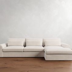 a white couch sitting on top of a wooden floor