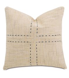 a beige pillow with black stitching on it