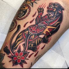 a man's arm with a tattoo on it that has an elephant and flowers