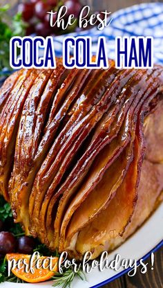 a ham on a platter with orange slices and rosemary garnish is featured in the ad for cocoa cola ham