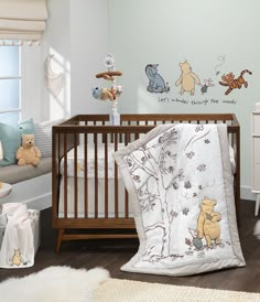 a baby's room with winnie the pooh wall decals and crib bedding