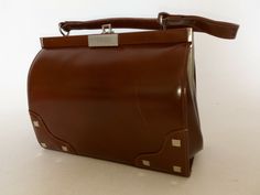 Formal Brown Shoulder Bag With Detachable Handle, Vintage Brown Rectangular Shoulder Bag For Office, Rectangular Vintage Brown Shoulder Bag For Office, Vintage Brown Shoulder Bag With Hasp Closure, Brown Bag With Top Carry Handle, Medium Brown Bag With Top Carry Handle, Brown Medium Bag With Top Carry Handle, Brown Rectangular Satchel With Handles, Handheld Brown Satchel For Office