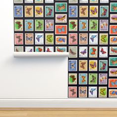 the wall is decorated with many different stamps and butterflies on it's side, along with a wooden floor