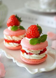 strawberry shortcakes with whipped cream and fresh strawberries on top are ready to be eaten