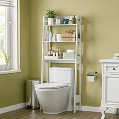 a white toilet sitting in a bathroom next to a shelf with bottles on top of it