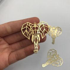 2 pcs Raw Brass Origami Elephant Charms, Geometric Elephant Pendant, Animal Jewelry, Elephant Head Necklace, African Earring Charm Size information is shared below Material; Brass Size: 40x45mm Hole Size: 1.7mm Plating: Raw Quantity: Optional If there is any other product you are interested in, please check our site below; All of our products are designed and manufactured by us. If you want to order more products in stock, you can freely contact us. Our Products; -Nickel-free -Lead-free -High qu Laser Cut Metal Jewelry Gift, Geometric Elephant, Origami Elephant, Earring Charm, Necklace African, Head Necklace, Laser Cut Jewelry, African Earrings, Jewelry Drawing