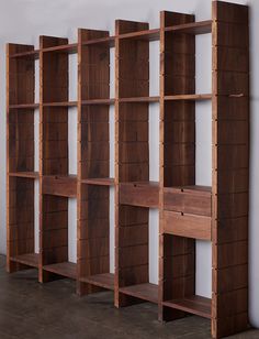 the wooden shelves are lined up against the wall and ready to be used as bookshelves