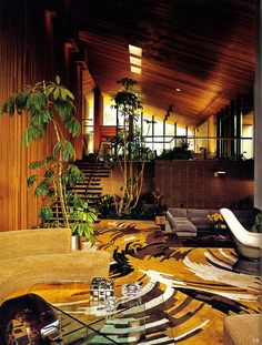 a living room filled with furniture and plants