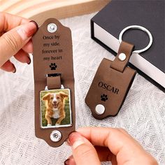 a person holding a keychain with an image of a dog on it