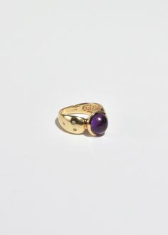 Stunning vintage gold ring with round amethyst cabochon and petite sapphire detail. Stamped 10k. Material: 10k gold, amethyst, sapphire. We recommend storing in a dry place and periodic polishing with a cloth. Gold Heirloom Amethyst Birthstone Ring, Heirloom Gold Birthstone Ring With Amethyst, Gold Amethyst Ring With Center Stone, Formal Amethyst Birthstone Ring With Round Stone, Heirloom Amethyst Birthstone Ring In Gold, Heirloom Amethyst Ring In Yellow Gold, Formal Amethyst Birthstone Ring, Yellow Gold Birthstone Ring With Amethyst Center Stone, Heirloom Amethyst Ring With Center Stone In 14k Gold