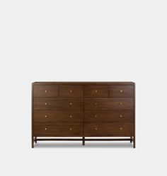 the chest of drawers is made out of wood and has brass pulls on each drawer