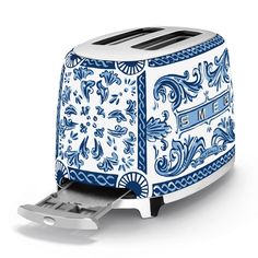 a blue and white toaster sitting on top of a counter next to a knife