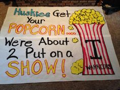 a sign with popcorn on it that says, hushes get your popcorn we're about 2 put on a show