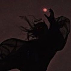 the silhouette of a woman with long hair and red eyes, holding her arms up in the air