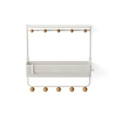 a white shelf with three balls hanging from it's sides and two shelves on each side