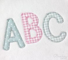 the letter abc is made up of pink and blue gingham