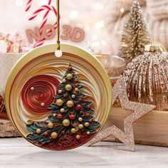 an ornament with a christmas tree on it next to other ornaments and decorations