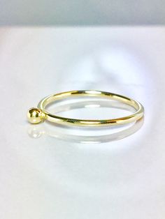 Cute and Dainty solid gold droplet ring Great for baby/children and adults fingers Very sparkly Pave diamond cut or smooth polished finish. **Gold: 14k/10k Real Solid Gold **Thickness approx : 1.0mm **Droplet size: 2.0mm Sturdy and well designed and great for any occasion. **Order yours Today! Minimalist 14k Gold Teardrop Ring, Gold Teardrop 14k Gold Ring, Tiny Gold Birthstone Ring With Round Band, Adjustable Yellow Gold Teardrop Rings, Adjustable Teardrop Yellow Gold Ring, Yellow Gold Teardrop Ring With Birthstone, Dainty Teardrop Gold Ring, Minimalist Teardrop Gold Ring, Simple Gold Stackable Birthstone Ring