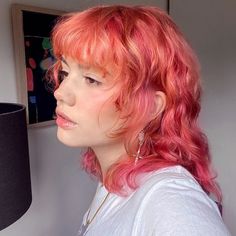 a portrait of a young woman with hot pink hair and mullet hairstyle Pink Red And Orange Hair, Shag Mullet Thick Hair, Autumn Vivid Hair Color, Cute Pink Hair Dye Ideas, Mullet Layered Hair, Orange To Pink Hair, Pink And Orange Hair Short, Ginger Hair Pink Highlights, Lesbian Flag Hair