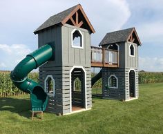 a play house with a slide in the grass