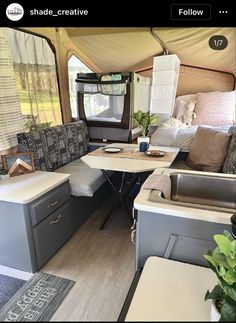 the inside of an rv with couches and tables