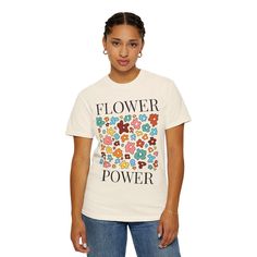 NOTE: The white, ivory, bay, chambray and blossom versions of this shirt are printed with black font. All other colors are printed with white. Embrace effortless boho chic with our Comfort Colors Garment-Dyed T-Shirt, featuring a vibrant Flower Power design. This relaxed tee is crafted from premium, ring-spun cotton and garment-dyed for a rich, lived-in feel. The front showcases an eye-catching boho floral graphic, radiating positive vibes and vintage charm. With its soft texture and relaxed fit, this shirt is perfect for layering or wearing solo. Available in a range of unique, faded hues, it's the ultimate addition to your laid-back, stylish wardrobe. Comfort Colors introduces the "Comfort Colors 1717" garment-dyed t-shirt; a fully customizable tee made 100% with ring-spun cotton. The so Beige Letter Print T-shirt For Spring, White Organic Cotton Tops For Spring, Beige Printed Cotton Tops, Printed Beige Cotton Tops, Beige Printed Cotton Shirt, Beige Cotton Printed Shirt, Trendy Beige Cotton Shirt, Off White Cotton Short Sleeve T-shirt, Cream Tops With Screen Print For Spring