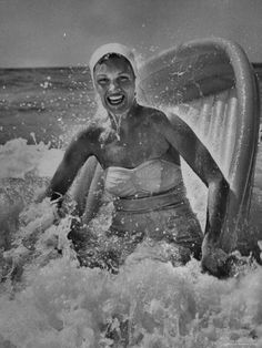 an old photo of a woman in the water