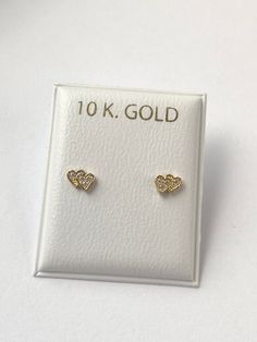 Solid yellow gold stud earrings, with a  gorgeous gold heart shape with cubic zirconia , perfectly designed for all ages but crafted with safety screw backs to protect the ears of children young girls and toddlers.  The 10K gold earring is perfect for babies, young girls and teenagers and beautiful enough for adults as well. Details: Metal: 10K Solid Gold Size: 3.8x5mm Back: screw back Condition: New Note: All parts are inspected before shipping, we are not responsible if you/or your baby lost the backings.  This Jewelry is meant to be adorned under adult supervision. Never leave young children unattended with our products. Please understand that the photos are ENLARGED to show detail for your benefit- please use the measurements provided in the item details/description to understand the s 14k Gold Heart Earrings For Mother's Day, Mother's Day 14k Gold Heart Earrings, 14k Yellow Gold Earrings For Birthday, Gold Double Heart Earrings For Anniversary, Gold Heart Birthstone Earrings For Valentine's Day, Double Heart Earrings With Diamond Accents As Gift, Gold Diamond Earrings For Wedding On Valentine's Day, Gold Heart Earrings With Cubic Zirconia, Gold Cubic Zirconia Pierced Heart Earrings