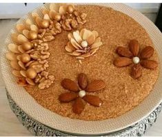 there is a cake with nuts and flowers on it