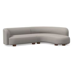 the curved sectional sofa with wooden legs is shown in light gray fabric, and has a rounded