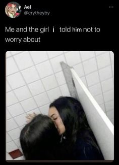 two people are kissing in the bathroom next to a wall with white tiles on it