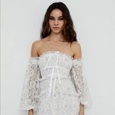 For Love & Lemons Lace Dress Size: S New With Tag Original: $398 50 Shades Of Summer. Dreamy And Flowing Lurex Daisy Lace Off- The-Shoulder Dress Featuring Decorative Bows, A Hi-Low Tiered Skirt, And Billowing Sleeves. Invisible Zipper At Back, Partially Lined. Fabric Composition: 90.1 % Nylon/9.9% Metallic Fiber; Contrast: 86% Viscose/14% Metallic; Lining: 98% Recycled Polyester/2% Spandex Please Note, Lowball Offers Will Not Be Accepted Elegant Off-shoulder White Lace Dress, Off-shoulder Lace Dress For Spring Wedding, Off-shoulder Lace Wedding Dress For Spring, Spring Wedding Off-shoulder Lace Dress, White Feminine Dress For Brunch, White Off-shoulder Lace Dress, Feminine White Dress For Brunch, White Off-shoulder Lace Mini Dress, White Off-shoulder Mini Dress For Brunch