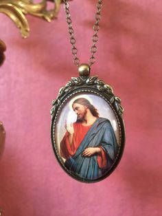 Beautiful pendant of Jesus Christ. The pendant is approx. 2,2 x1,6 inch (5,5 x 4 cm) and is set in a leadfree antique brass setting. The necklace is a very fine leadfree antique brass metal chain (length approx. 42cm). Due to the shape of the glass cabochon the light is reflected, so the real pendant is much more beautiful than the picture. The pendant is delivered in a nice gift pouch. Please feel free to follow me on Pinterest and instagram! Christ Necklace, Jesus Necklace, Antique Brass Metal, Gift Pouch, Oct 30, Brass Metal, Metal Chain, Chain Lengths, Chain Length