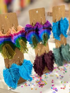 several colorful tassels are on display in front of confetti