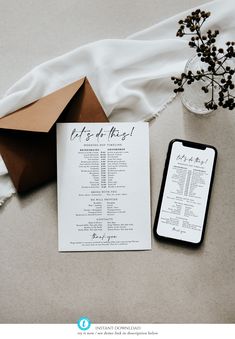 the wedding program is displayed next to an envelope and phone on top of a table