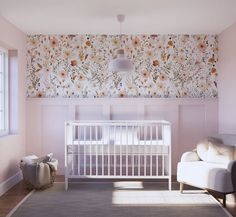 a baby's room with white furniture and flowers on the wall