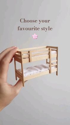 a hand holding a miniature bunk bed with the words choose your favorite style above it