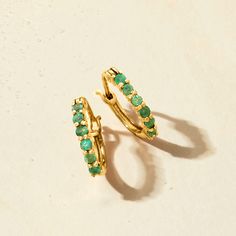 Ross-Simons - .40ct t. w. Emerald Huggie Hoop Earrings in 14kt Yellow Gold. 1/2". RS Pure. Modern designs that complete your outfit and complement your personality. Liven up your everyday looks with these petite huggie hoop earrings featuring .40 ct. t. w. round emeralds in 14kt yellow gold. Solo or stacked with simple studs, they will become a favorite in your minimalist rotation. Hanging length is 1/2". Snap-bar, emerald huggie hoop earrings. Emerald birthstones are the perfect gift for May bi Stackable Yellow Gold Earrings For Anniversary, Anniversary Stackable Yellow Gold Earrings, Anniversary Huggie Earrings With May Birthstone, Anniversary Gift May Birthstone Round Huggie Earrings, Emerald Hoop Earrings For Anniversary, Elegant May Birthstone Huggie Earrings For Anniversary, Small Hoop Huggie Earrings With Gemstones For Anniversary, Stackable Yellow Gold Earrings Fine Jewelry, Elegant Small Hoop Stackable Earrings