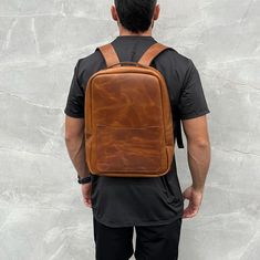 This customisable backpack is the epitome of minimalist elegance. Crafted from high-quality leather, it exudes sophistication and refinement. The backpack features a sleek design that's perfect for those who prefer a more understated look. 🔷The main compartment is spacious enough to fit a laptop of up to 15 inches. 🔷In addition to the laptop compartment, the backpack features a front pocket that's perfect for storing smaller items like your phone, keys, or wallet.  The backpack also comes with Modern Everyday Backpack With Waxed Finish, Everyday Leather Backpack With Smooth Grain, Daily Use Leather Backpack With Smooth Grain, Everyday Rectangular Leather Backpack With Smooth Grain, Modern Brown Backpack For Everyday Carry, Minimalist Leather Travel Backpack, Rectangular Smooth Leather Backpack, Modern Travel Backpack With Smooth Grain, Modern Rectangular Leather Backpack For Everyday