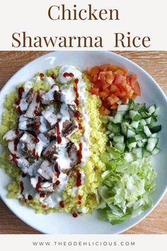 chicken shawarma rice on a white plate with lettuce and tomatoes