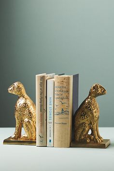 two golden bookends sitting next to each other