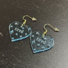 "Whether you're conquering a busy day or dancing the night away, these earrings are designed to keep up with your sparkle, even when you're feeling a bit tired. Our handmade, unique heart-shaped earrings are made with beautiful blue fluorescent cast acrylic! The light blue hue is color-shifting in different levels of light and is transparent. These earrings are not solely blue, despite the way they look in photos sometimes.  ♥ Our heart-shaped earrings are 1.2\" W x 1.2\" H with a 1/8\" (3mm) thickness. ♥ Our earrings are uniquely designed and handmade in Columbus, Ohio. All orders are made-to-order with love and attention to detail. ♥ Our high quality heart-shaped earrings come with a glass-like glossy finish. The glossy finish is on the front and back. ♥ The transparent acrylic allows so Trendy Heart Hoop Earrings For Party, Trendy Heart-shaped Hoop Earrings For Party, Trendy Dangle Heart Earrings, Trendy Pierced Heart Dangle Earrings, Trendy Dangle Heart Earrings With Ear Wire, Trendy Clear Hoop Earrings For Parties, Trendy Clear Hoop Earrings As Gift, Trendy Clear Hoop Earrings, Perfect As Gift, Adjustable Trendy Heart Earrings