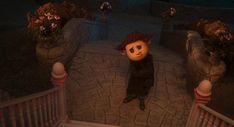 an animated character is standing in the middle of a walkway with flowers on either side